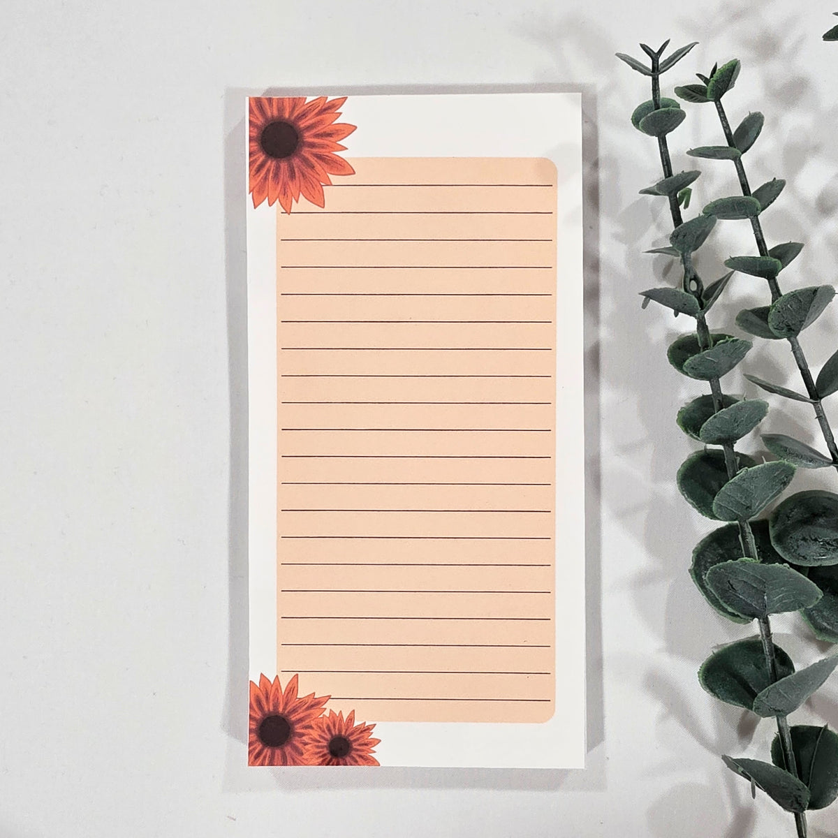 Notepad with floral design on a white background