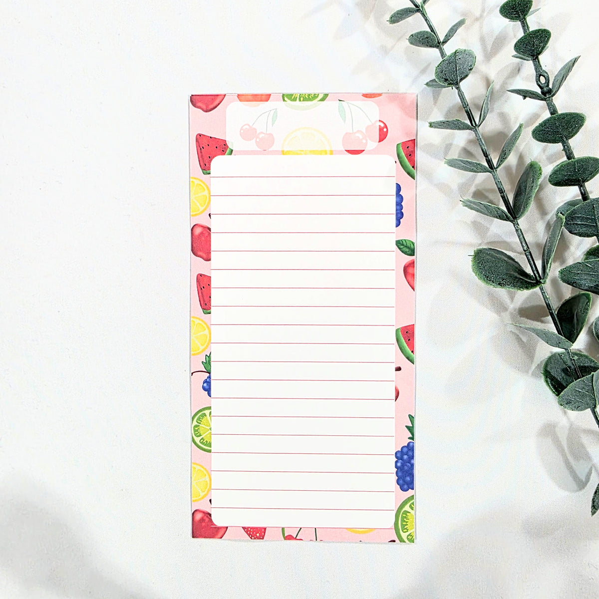 Notepad with colorful fruit pattern on a white background