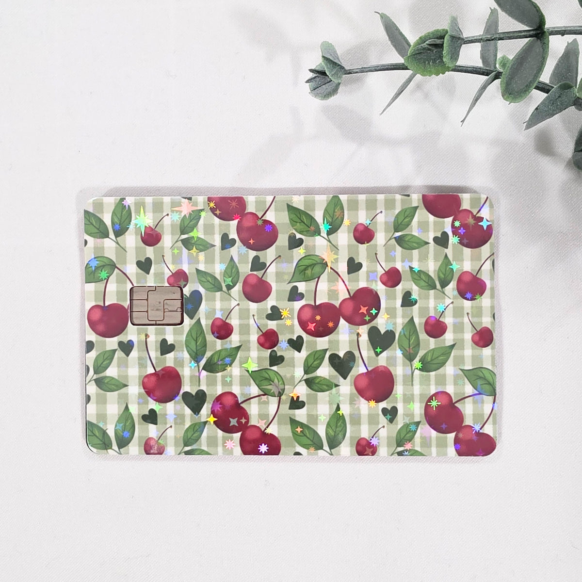 Sparkle holographic, green cherry gingham credit card sticker applied to standard card