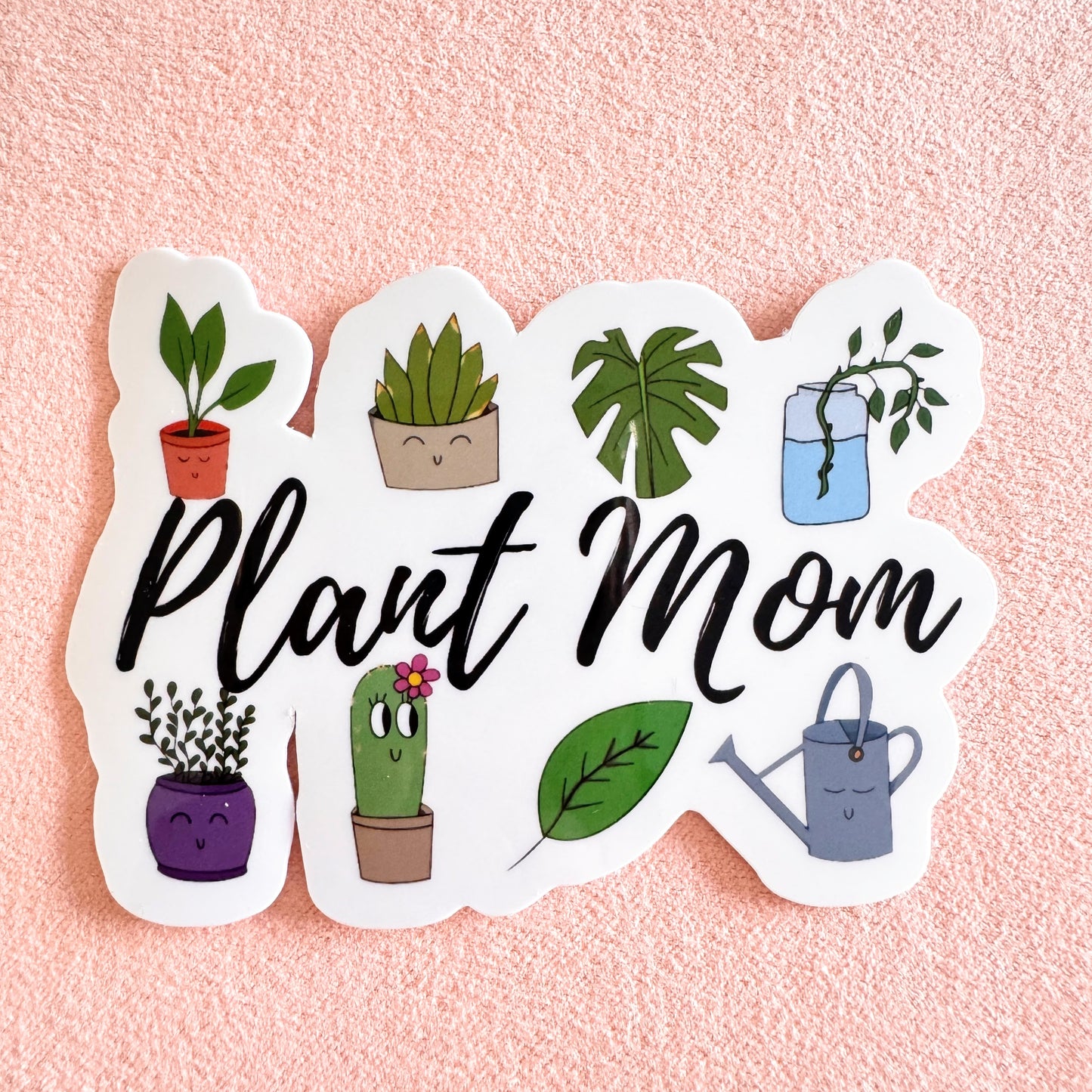 3-inch handmade sticker with the text "Plant Mom" surrounded by green leaves. Features original artwork, a laminated, water-resistant finish, and is perfect for decorating water bottles, laptops, and journals. A cute and fun design for plant lovers and proud plant parents.