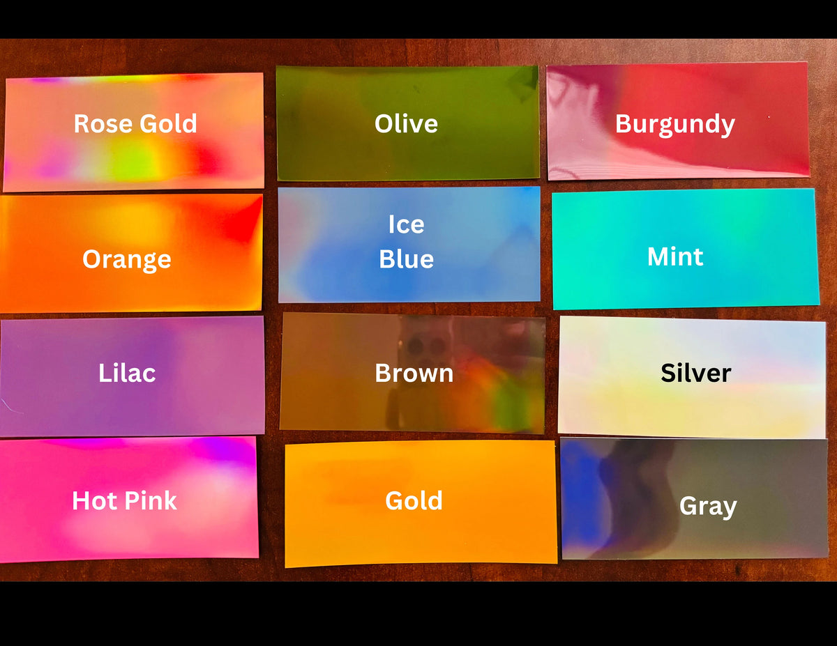 Color swatches of holographic vinyl labeled with names on a wooden background