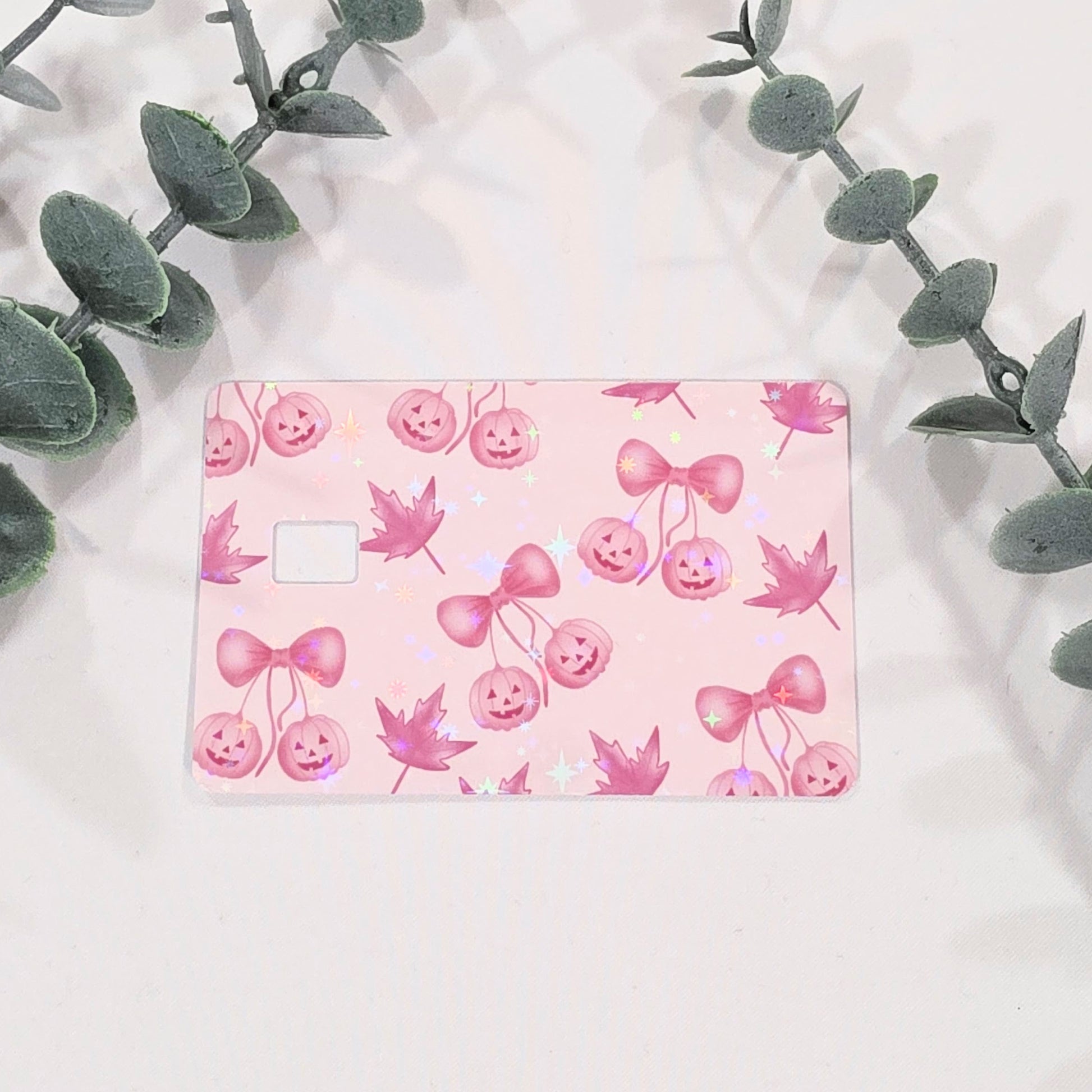 Pink card with pumpkins and bow design on a light pink background