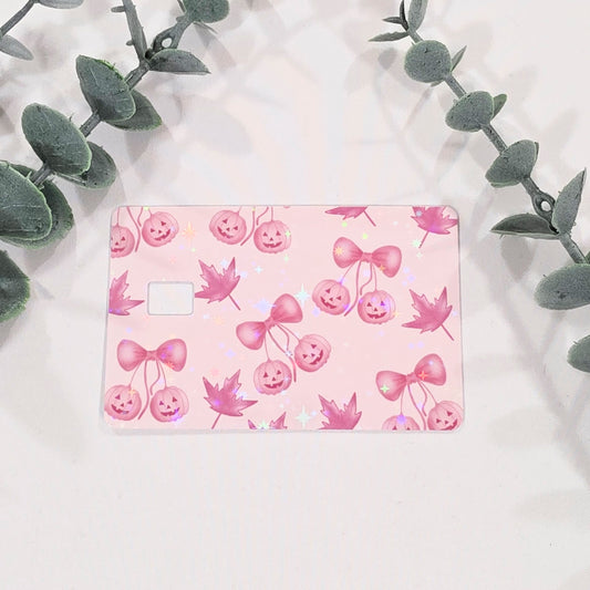 Pink card with pumpkins and bow design on a light pink background