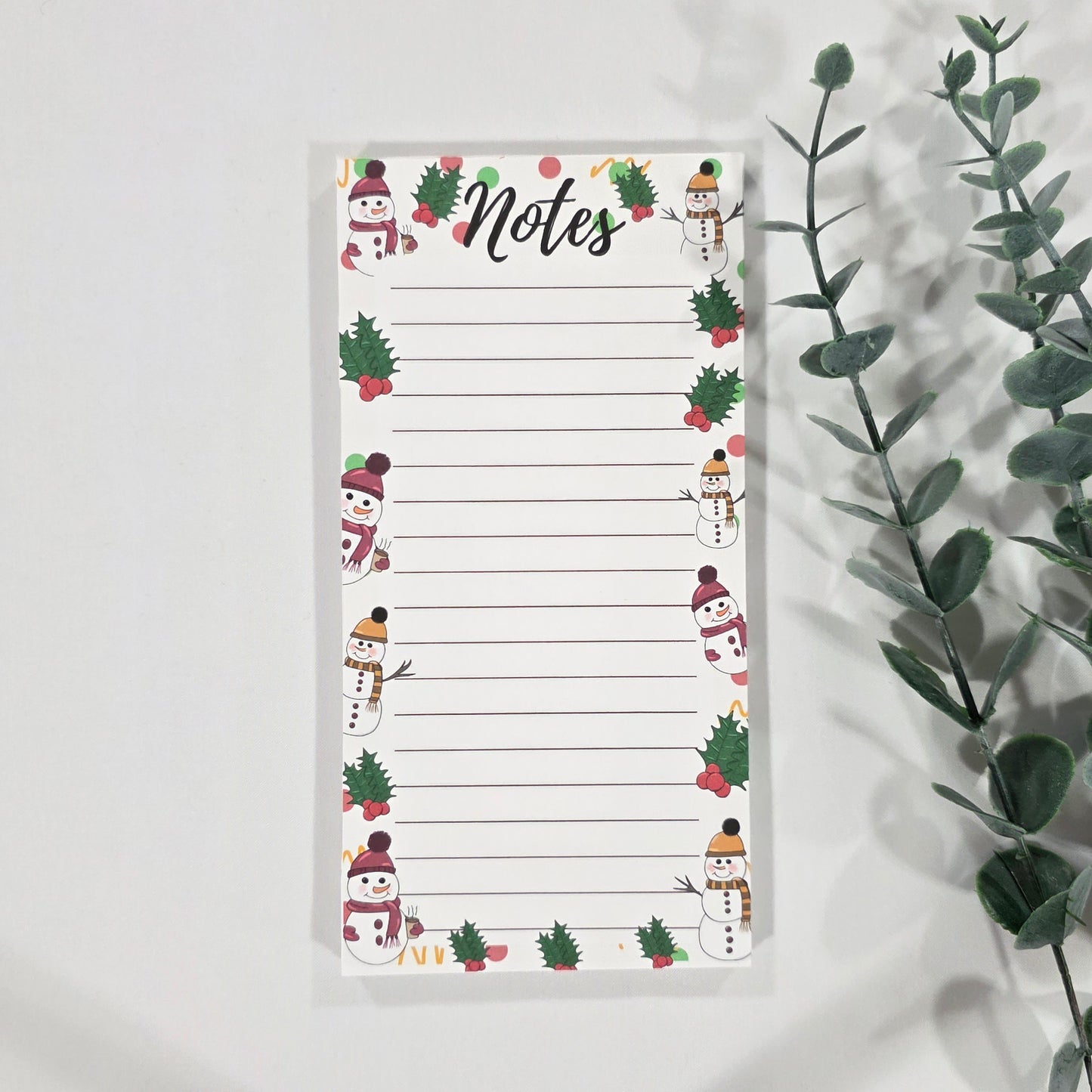 Notepad with Christmas-themed design on a white background