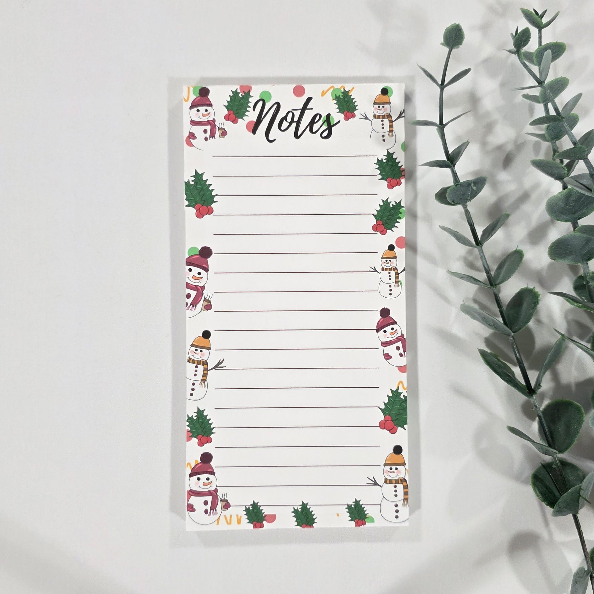 Notepad with Christmas-themed design on a white background