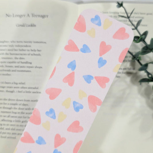 Pink bookmark with heart pattern on a book