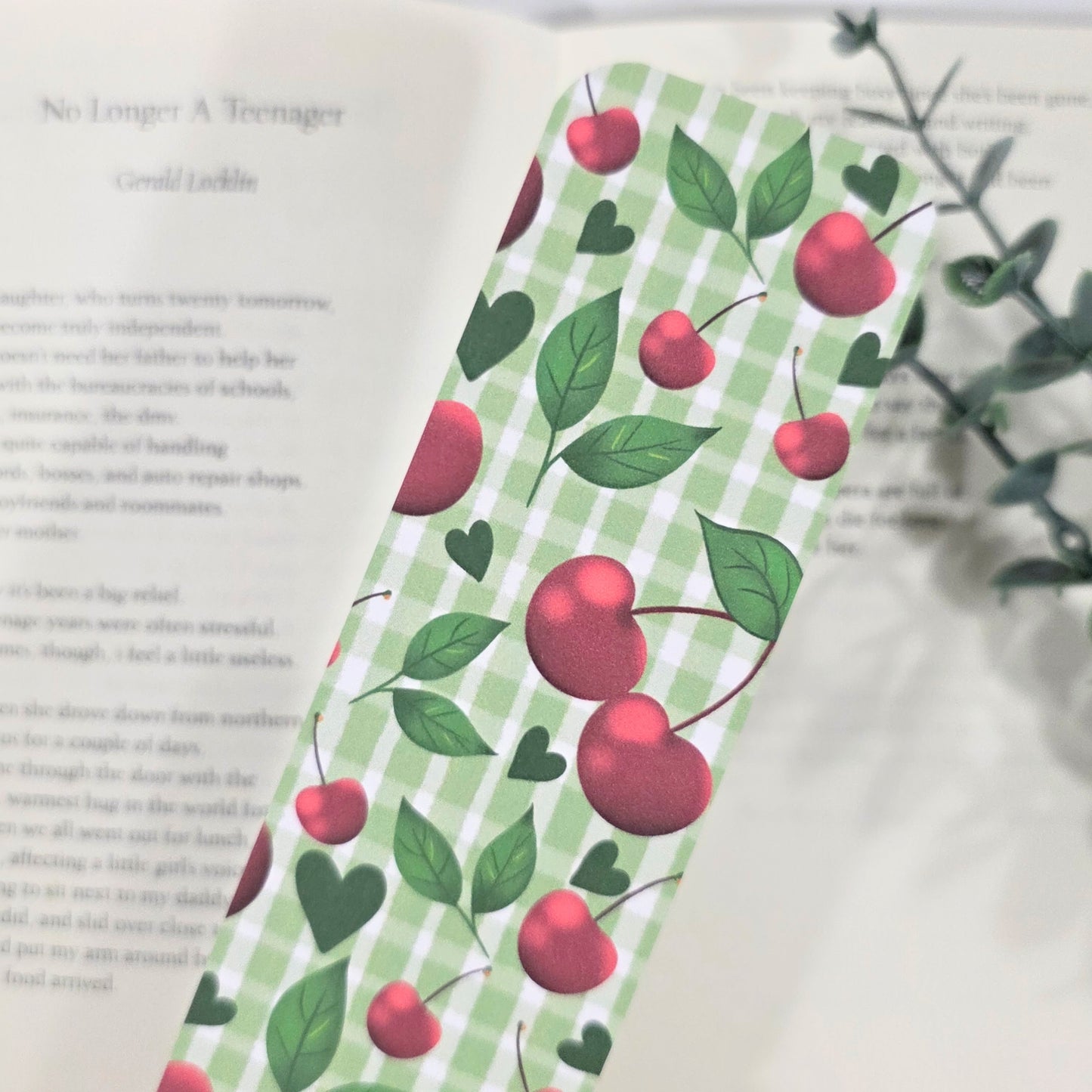 Bookmark with cherry pattern on a book. Green Gingham