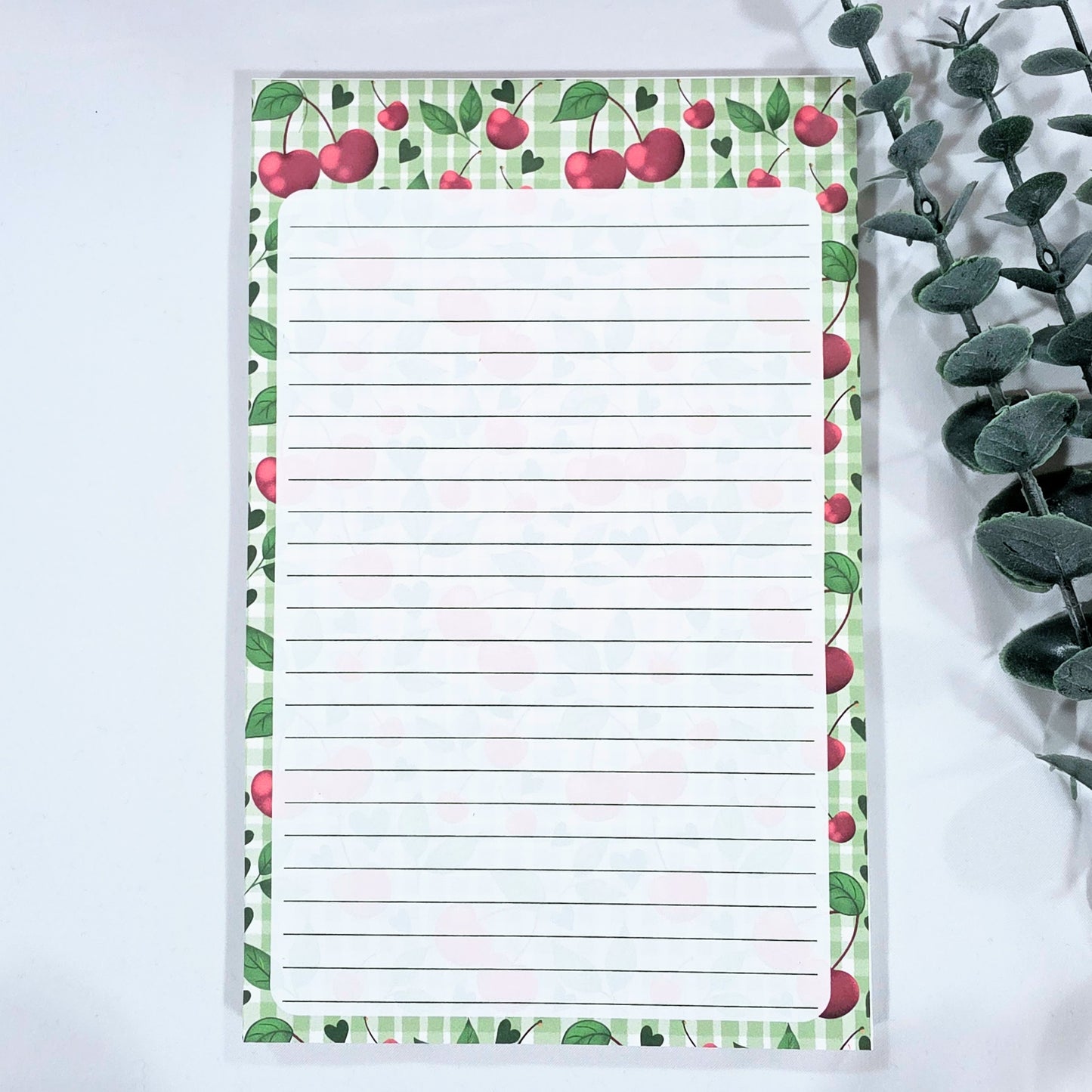 Notepad with cherry design on a white background