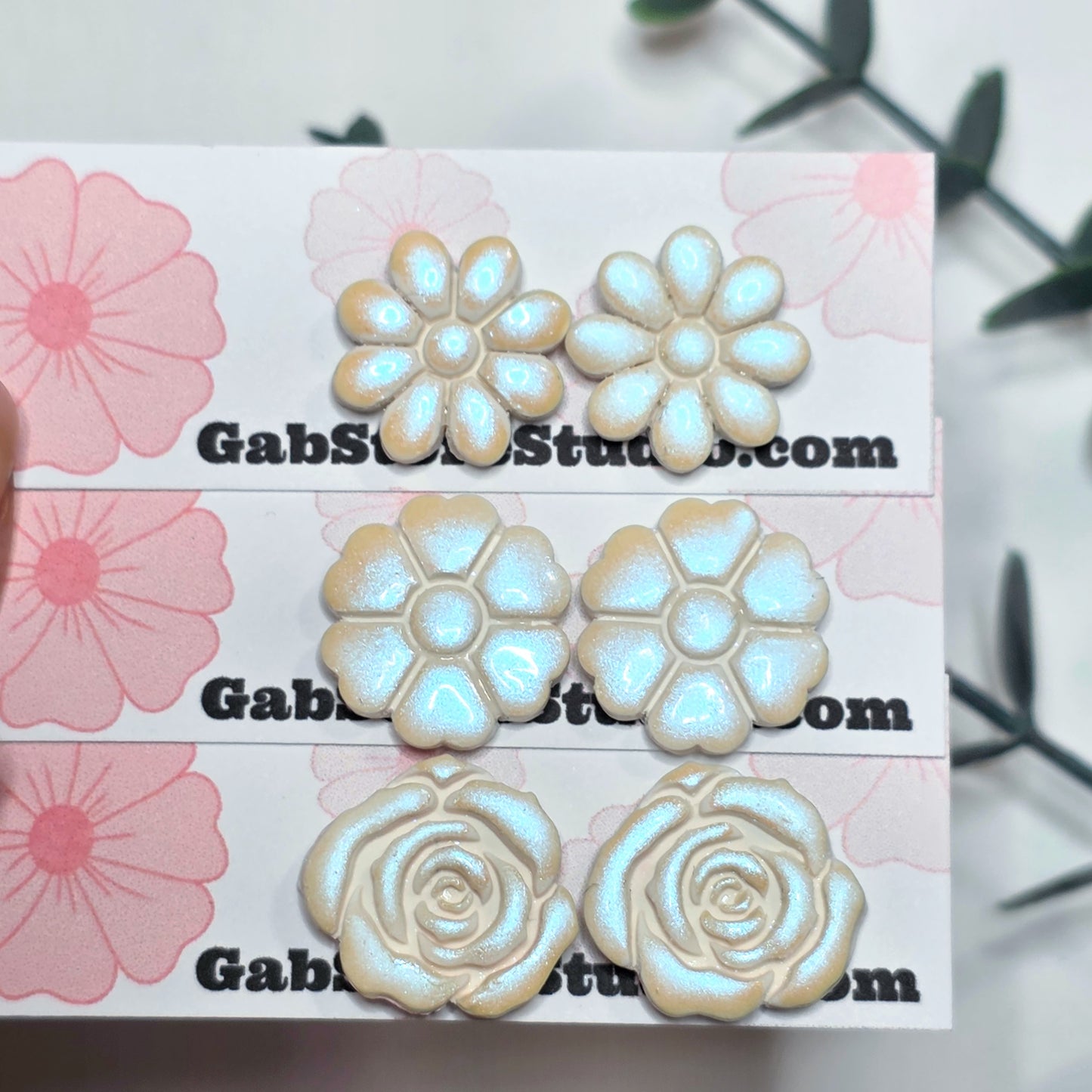 Floral earrings on a branded card with floral designs