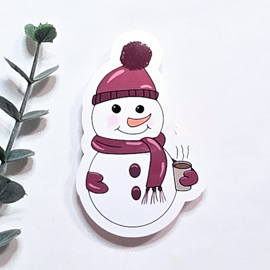 Cartoon snowman with a pink hat and scarf holding a cup on a white background